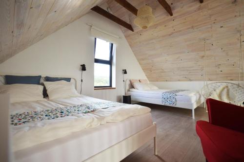 een slaapkamer met 2 bedden in een kamer met houten wanden bij Siedlisko Ciemno in Ciemno