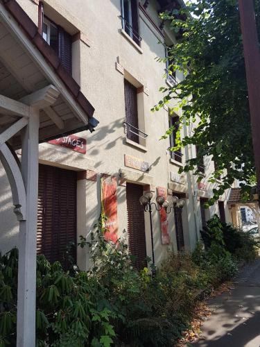 a building with a sign on the side of it at L'AUBERGADE Bis in Vittel