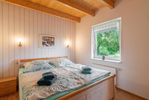 a bedroom with a bed with towels on it at Ferienhaus Natzel in Darlingerode