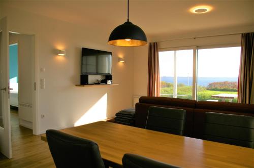 a living room with a table and a couch at Witt am See L in Klein Wittensee