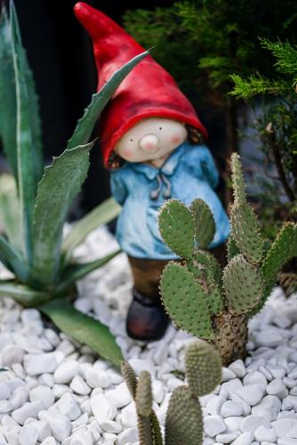 a figurine of a gnome standing next to some cactus at Stile Suite Family Hotel in Antalya