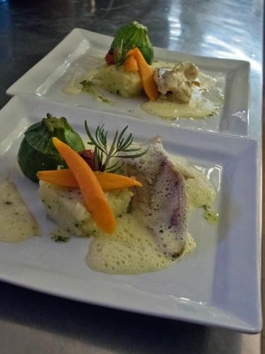 a plate of food with carrots and other foods at Hotel-Restaurant Le Moulin De La Camandoule in Fayence