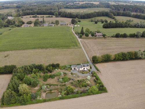 an aerial view of a house in a field at Gîte La Grenouillère in Esquéhéries