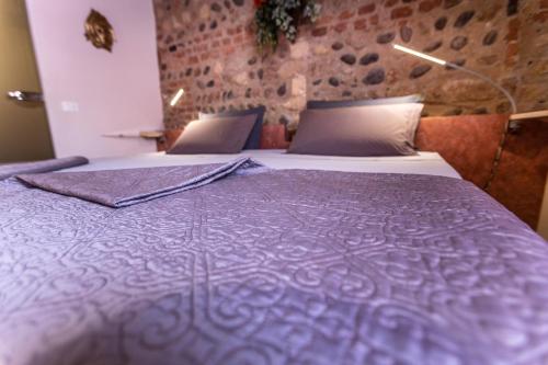 Un ou plusieurs lits dans un hébergement de l'établissement La Bella Verona Wine Suite