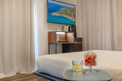 a hotel room with a tray of fruit on a table at HOTIDAY Room Collection - Olbia Wallure in Olbia