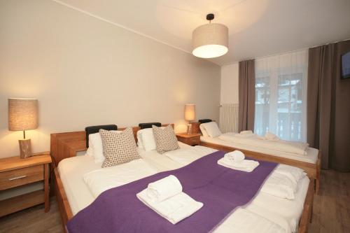 - une chambre avec 2 lits et des serviettes dans l'établissement Relaxappartement Wymbs, à Zell am See