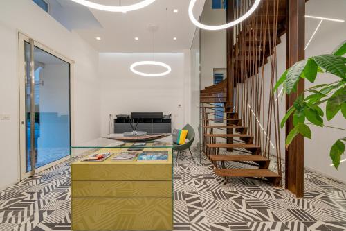 a hallway with a staircase with a glass counter at HOTIDAY Room Collection - Olbia Wallure in Olbia
