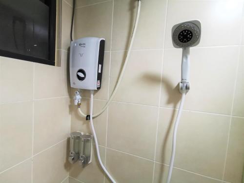 a bathroom with a shower with a phone on the wall at Infistay Homestay - Sunway Geo Avenue, Sunway Pyramid, Sunway Lagoon, Sunway University, Sunway Medical Centre in Subang Jaya