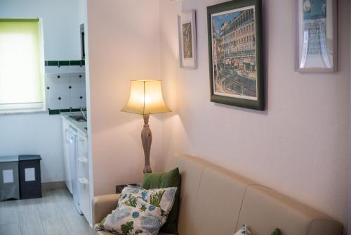 a living room with a lamp and a couch at Casas Burnay I in Ericeira