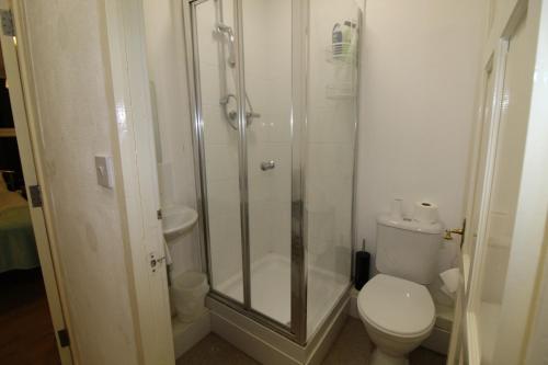 a bathroom with a shower and a toilet at PearTree House in Derby