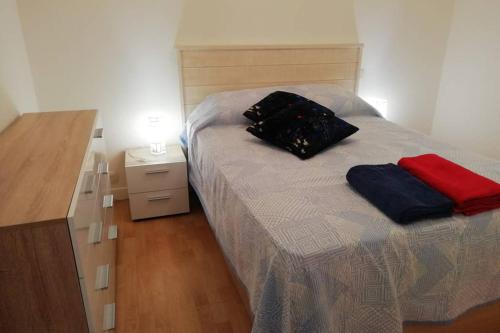 a bedroom with a bed with two bags on it at Le "LA FAYETTE", vue exceptionnelle sur le Port de Plaisance in Rochefort