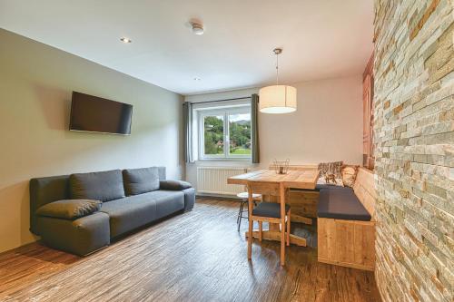 a living room with a couch and a table at Nockberge Lodge in Bad Kleinkirchheim