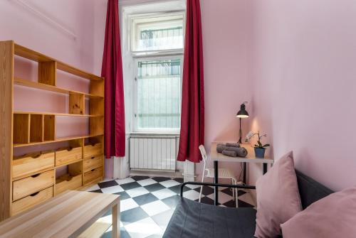 Habitación con cama, mesa y ventana en Budapest Three Cats Hostel, en Budapest