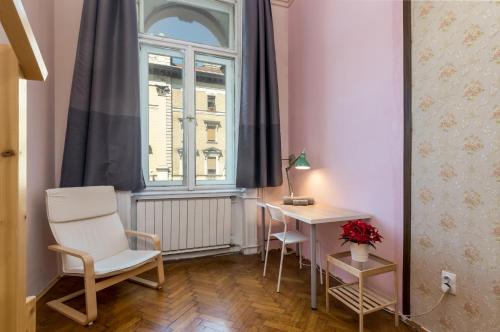 a room with a desk and a chair and a window at Budapest Three Cats Hostel in Budapest