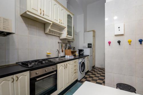a kitchen with a sink and a stove top oven at Budapest Three Cats Hostel in Budapest