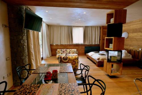 a living room with a bed and a table and chairs at MH Olen Boutique Hotel in Alagna Valsesia