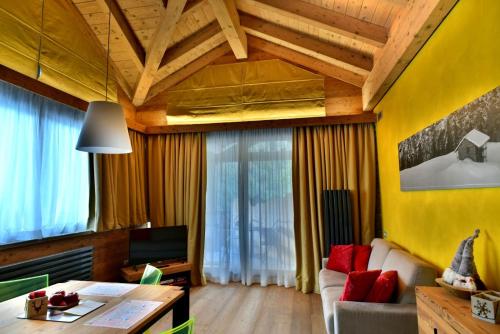 a living room with a couch and a table at MH Olen Boutique Hotel in Alagna Valsesia