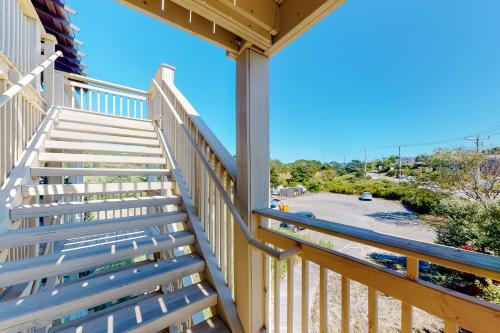 a balcony with stairs and a view of a parking lot at Sand & Beach Within Reach in North Truro