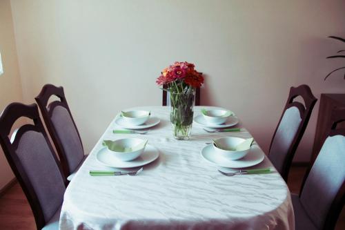 a table with a vase of flowers on it at Dom pod Górami in Mirsk