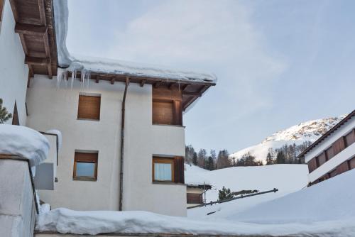 a building covered in snow with icicles on it at Chesa Sarvit 1 - Celerina in Celerina