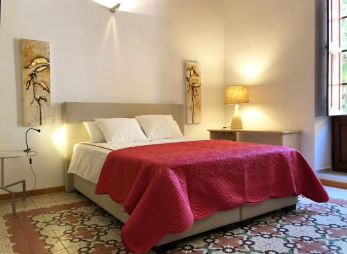 a bedroom with a bed with a red blanket on it at Diana 16 in Denia