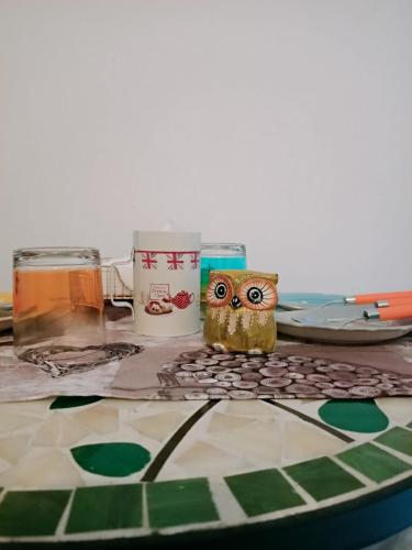 a table with an owl figurine sitting on a table at La casa sul tetto, Room's & Glamping in Recanati
