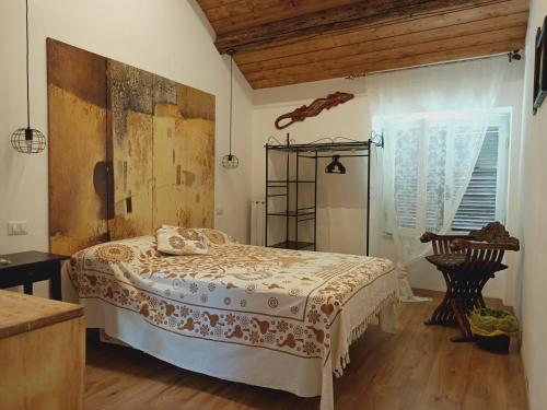a bedroom with a large bed in a room at La casa sul tetto, Room's & Glamping in Recanati