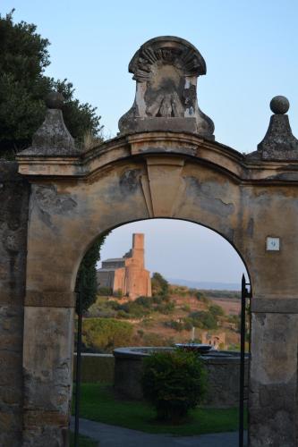 an archway with a castle in the background at Il Riuscello in Tuscania