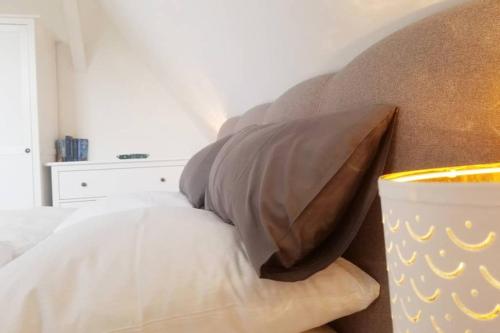 a bedroom with a bed with a pillow and a table at Villa Pries in Kiel