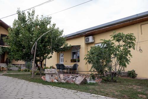 a house with two chairs sitting outside of it at Apartman Peric in Đakovo
