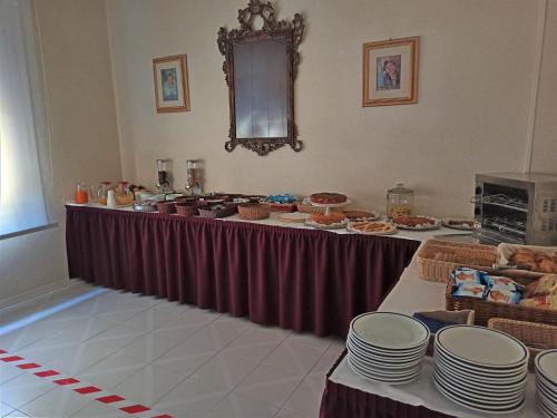 a long table with plates and dishes on it at Albergo Giglio in Chianciano Terme
