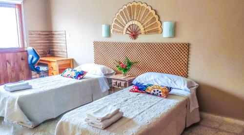 a room with two beds and a mirror on the wall at Casa Rural SOBRE EL MAR in Breña Baja