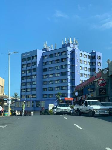 a large building with cars parked in a parking lot at Kings View in Margate