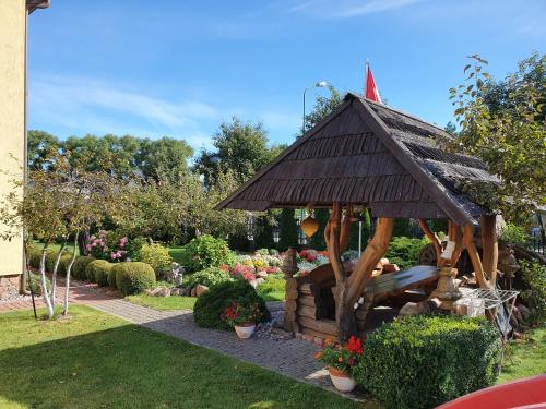 a small gazebo in the middle of a garden at Pas Birutę in Palanga