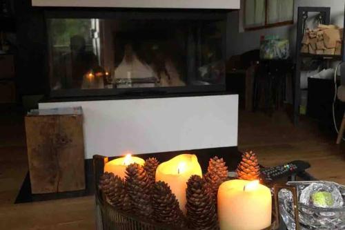 a group of candles on a table with pine cones at Chalet “In dai Guriuz” in Ravinis