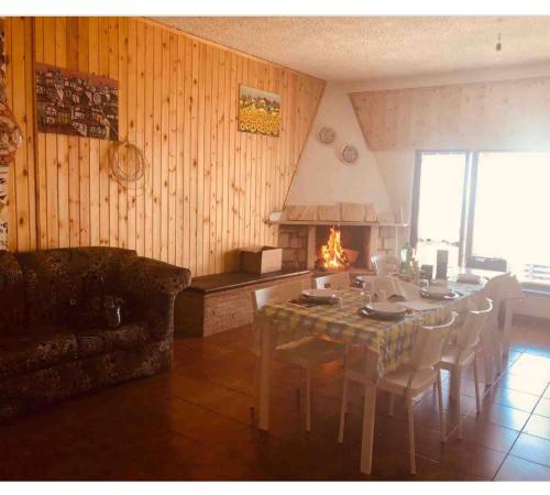 a living room with a table and a fireplace at Campo dell'Osso Sky 2 in Subiaco