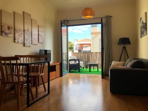 a living room with a couch and a table and chairs at Apartamentos da Carreira in Funchal