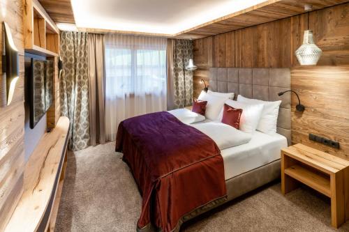 a hotel room with a bed and a television at Der Postwirt in Söll