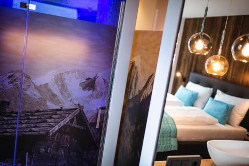 a room with a bed and a picture of a mountain at Chalet in Naturno