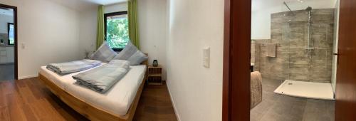 a small bedroom with a bed and a shower at Haus Nilson in Gengenbach
