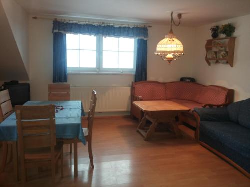ein Wohnzimmer mit einem Sofa und einem Tisch in der Unterkunft Dirnbergerhof in Mondsee
