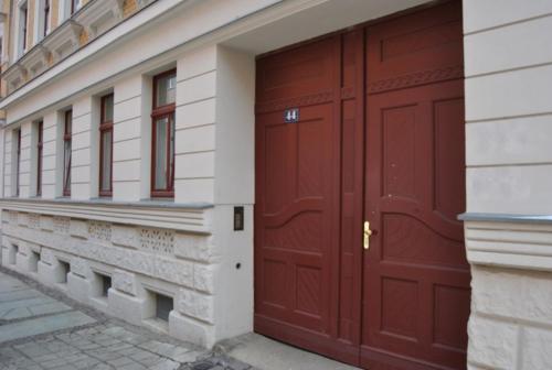 a pair of red doors on a building at Adoreo Apartments & Suites in Leipzig
