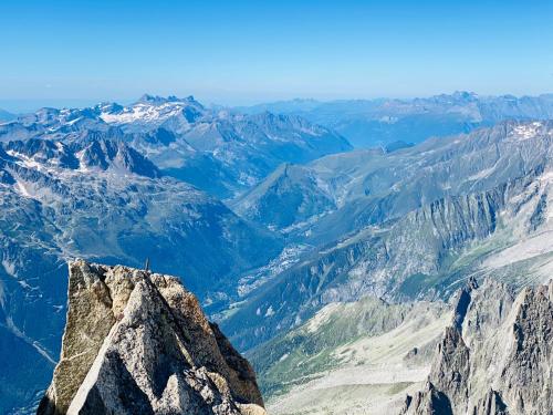 a person standing on top of a mountain at Rocky Studio Chamonix Sud in Chamonix-Mont-Blanc