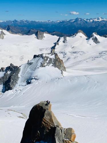 a person standing on top of a snowy mountain at Rocky Studio Chamonix Sud in Chamonix-Mont-Blanc