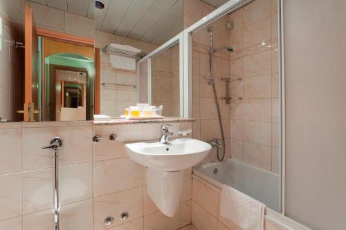 a bathroom with a sink and a shower at Villa Galijot Plava Laguna in Poreč