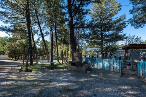 a park with a picnic table and a fence at Enchanted Hideaway Cabins and Cottages in Ruidoso