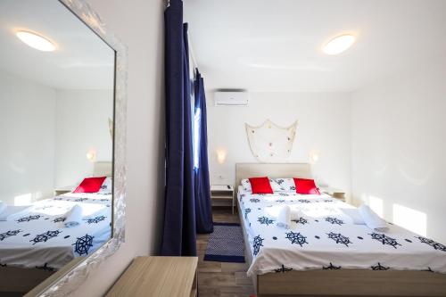 a bedroom with two beds and a mirror at 1oak rentals in Vir