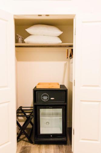 a room with a microwave in a closet at The Bishop Arts Hotel by Qresorts in Dallas
