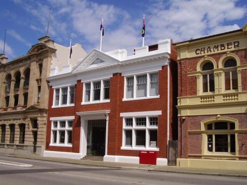a red brick building on a city street at Fremantle Harbourside Apartments in Fremantle