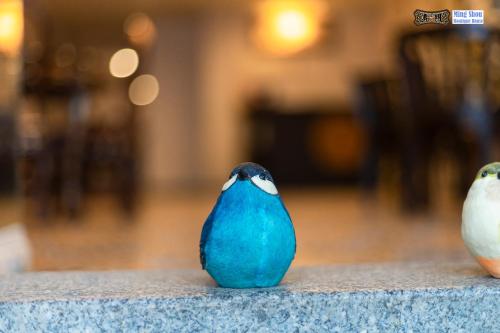 two birds are sitting on a table at Ming Shou Boutique House in Phuket Town